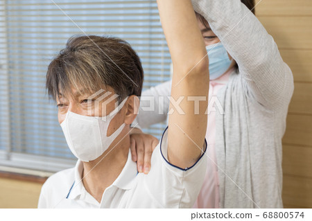 Seniors receiving rehabilitation 68800574