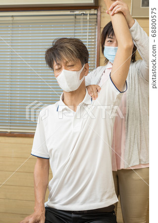 Seniors receiving rehabilitation 68800575
