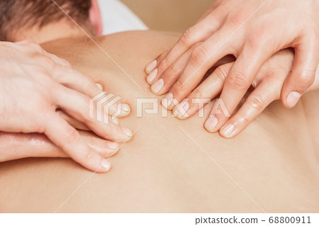 Back massage in four hands. Back massage in four hands. 68800911