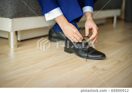 Groom is wearing shoes in blue wedding suit Groom is wearing shoes in blue wedding suit 68800912