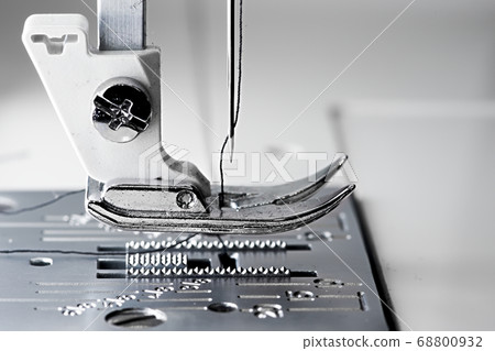 5 - Macro sewing machine side view with flat foot plate ready to stitch. 5 - Macro sewing machine side view with flat foot plate ready to stitch. 68800932
