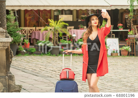 Pretty tourist girl is taking a selfie. Pretty tourist girl is taking a selfie. 68801196