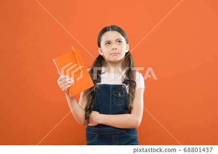 school girl read book on orange background. school girl read book on orange background. 68801437