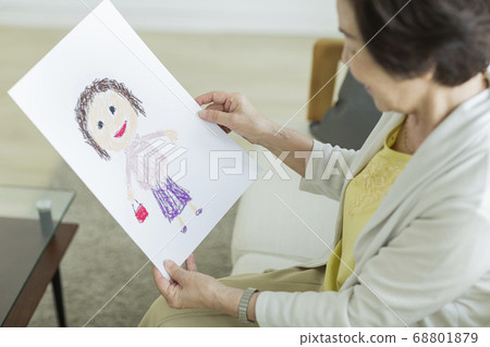 Senior woman happy looking at a caricature 68801879