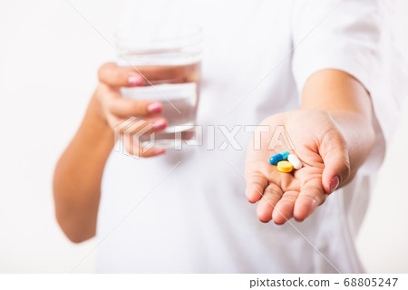Woman hold pill drugs in hand ready take medicines Woman hold pill drugs in hand ready take medicines 68805247