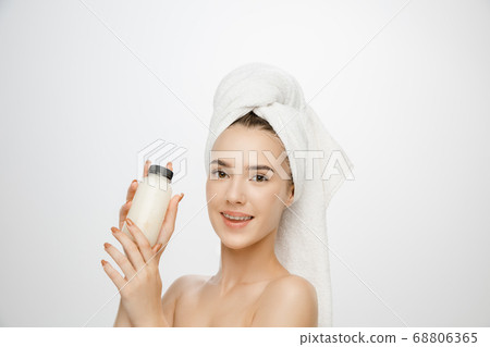 Beauty Day. Woman wearing towel isolated on white studio background Beauty Day. Woman wearing towel isolated on white studio background 68806365