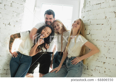 Group of adorable multiethnic friends having fun at home interior background 68806550