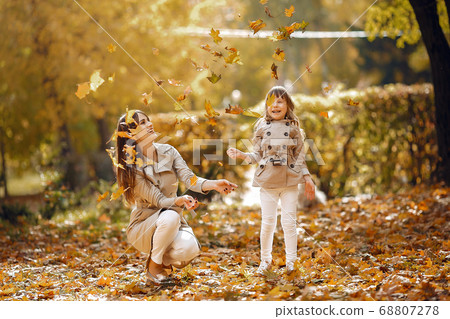Cute and stylish family in a autumn park Cute and stylish family in a autumn park 68807278