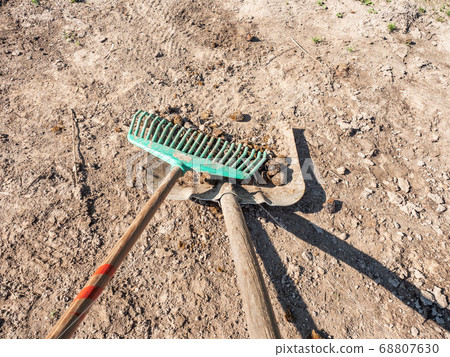 Farmer crearing big dung from a horse on ground Farmer crearing big dung from a horse on ground 68807630