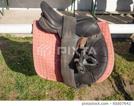 Plastic stirrups and leather strips on a dark Plastic stirrups and leather strips on a dark 68807642