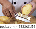 Chef peeling potato to make mashed Potatoes 68808154