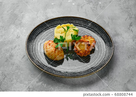 Ground meat cutlet with mashed potato and grilled 68808744