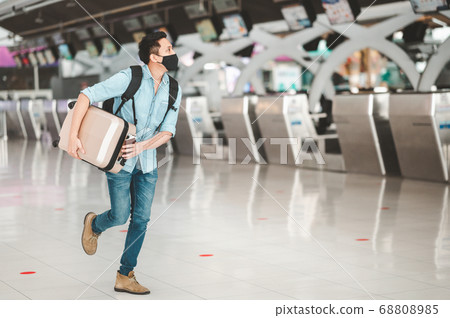Asian man wearing protective face mask running at Asian man wearing protective face mask running at 68808985