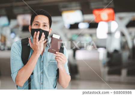 man tourist wearing face mask feeling surprised man tourist wearing face mask feeling surprised 68808986