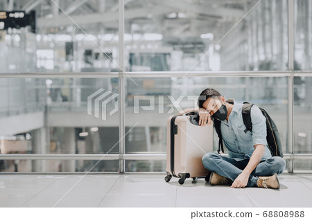 Asian man wearing face mask resting or sleeping on Asian man wearing face mask resting or sleeping on 68808988