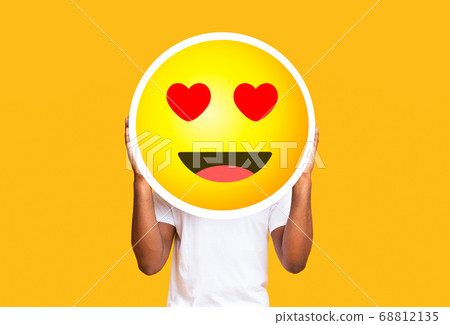 Unrecognizable black man hiding face against in love emoticon emoji 68812135