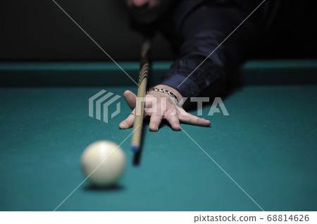 Playing billiard. Player arm gets ready to stroke 68814626