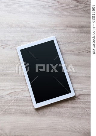 White tablet pc with empty screen on wood White tablet pc with empty screen on wood 68815605