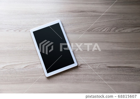 White tablet pc with empty screen on wood White tablet pc with empty screen on wood 68815607