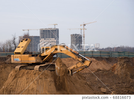 Excavator digs the ground for the foundation 68816073