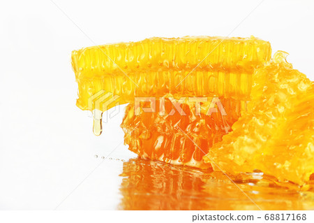 honey flowing from the honeycombs on a light 68817168