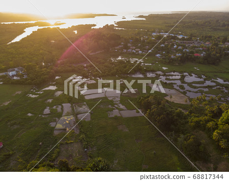 Aerial Drone shot of Chake Chake City, a Capital of Pemba island, Zanzibar archipelago. City in a river Delta at sunset time 68817344