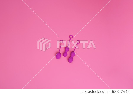 woman holds a kegel trainer. Latex vaginal vibrator for training the pelvic floor muscles with an woman holds a kegel trainer. Latex vaginal vibrator for training the pelvic floor muscles with an 68817644