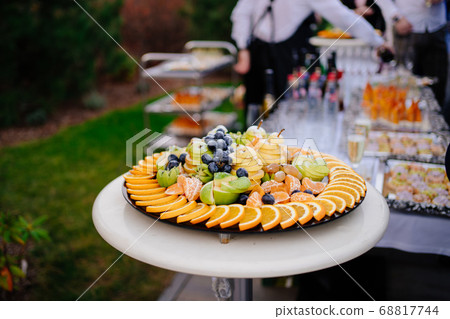 buffet in the open air. Plate fruit slicing. 68817744