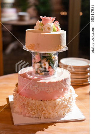 multi-tiered wedding cake with flowers and lace 68817982