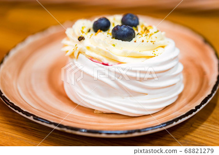 Meringue cake decorated with blue berry. Dessert 68821279