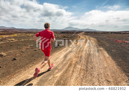 Runner athlete running in mountain trail. Fit man training cardio outdoors. Summer sport fitness run in desert landscape. Runner athlete running in mountain trail. Fit man training cardio outdoors. Summer sport fitness run in desert landscape. 68821932