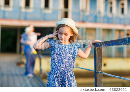 kid girl with mom and sister standing old bridge 68822031