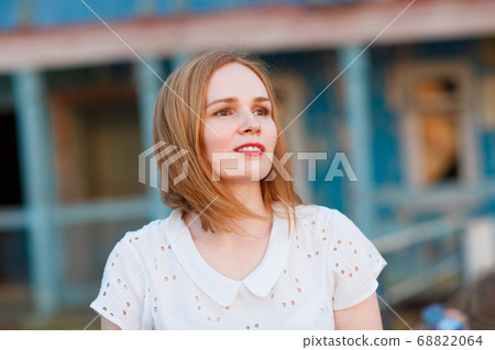 woman in stand old bridge, destroyed buildings. 68822064
