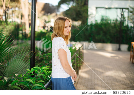 woman standing in park on site 68823655