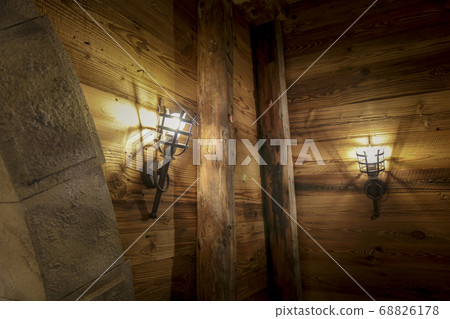 The lamp on the brown wooden in a mine . The lamp on the brown wooden in a mine . 68826178