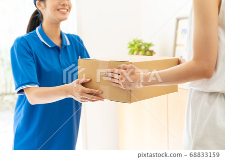 Courier female driver delivering luggage 68833159