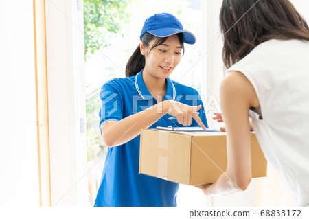 Courier female driver delivering luggage 68833172
