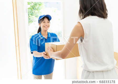 Courier female driver delivering luggage 68833178