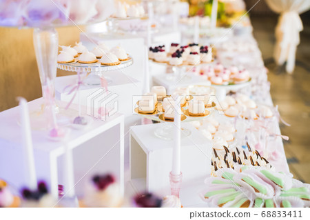 Delicious wedding reception candy bar dessert table Delicious wedding reception candy bar dessert table 68833411