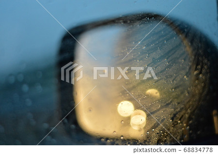 Side mirror of a car running in the rain Side mirror of a car running in the rain 68834778