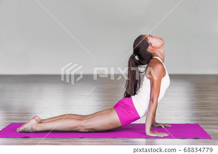 Upward facing dog backbend pose yoga woman. Urdhva mukha svanasana exercise Asian girl practicing. Yoga for weight loss. Upward facing dog backbend pose yoga woman. Urdhva mukha svanasana exercise Asian girl practicing. Yoga for weight loss. 68834779