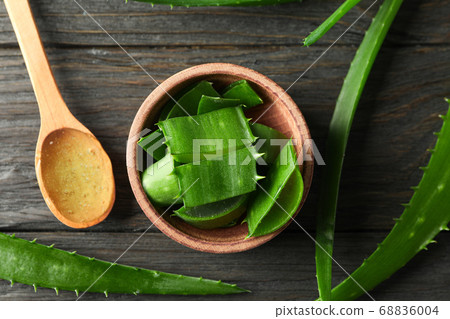 Aloe vera leaves and slices on wooden table, Aloe vera leaves and slices on wooden table, 68836004