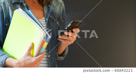 student with books and smartphone student with books and smartphone 68843221
