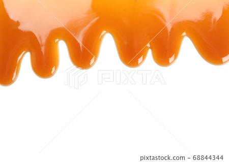 Flowing caramel sauce isolated on white 68844344