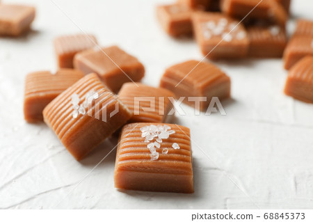 Salted caramel candies on white background, 68845373