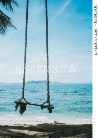 a lonely swing on the beach a lonely swing on the beach 68845936