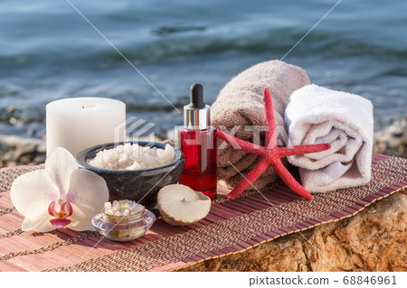 Spa products on bamboo napkin with seashore on the 68846961
