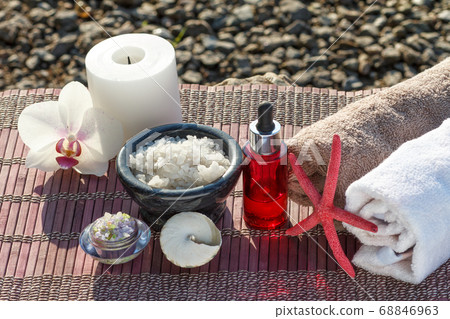 Spa products on bamboo napkin at seashore in sunny 68846963