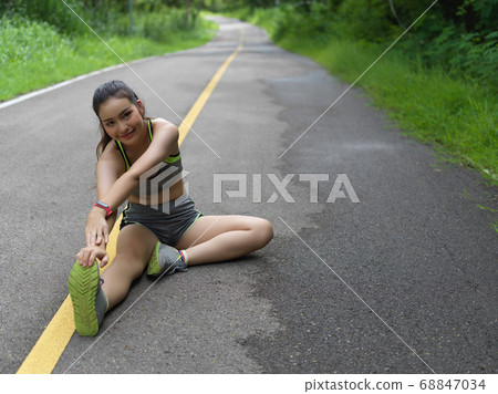Close up view of female in sportswear stretching Close up view of female in sportswear stretching 68847034