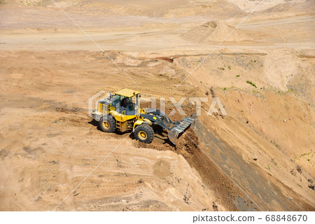 Front end loader has been recovering the landscape around the open pit 68848670